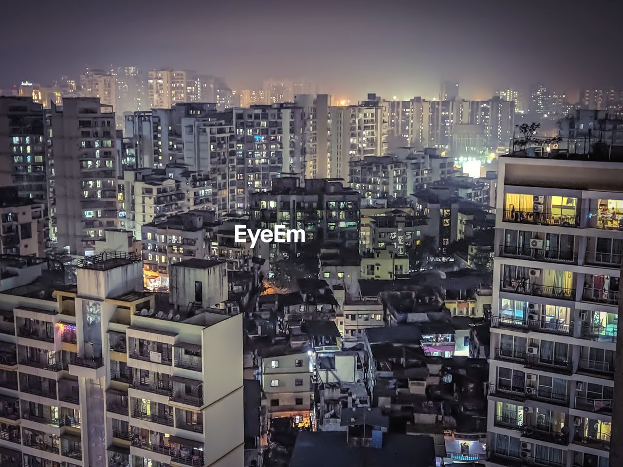 High angle view of illuminated buildings in city at night. 
