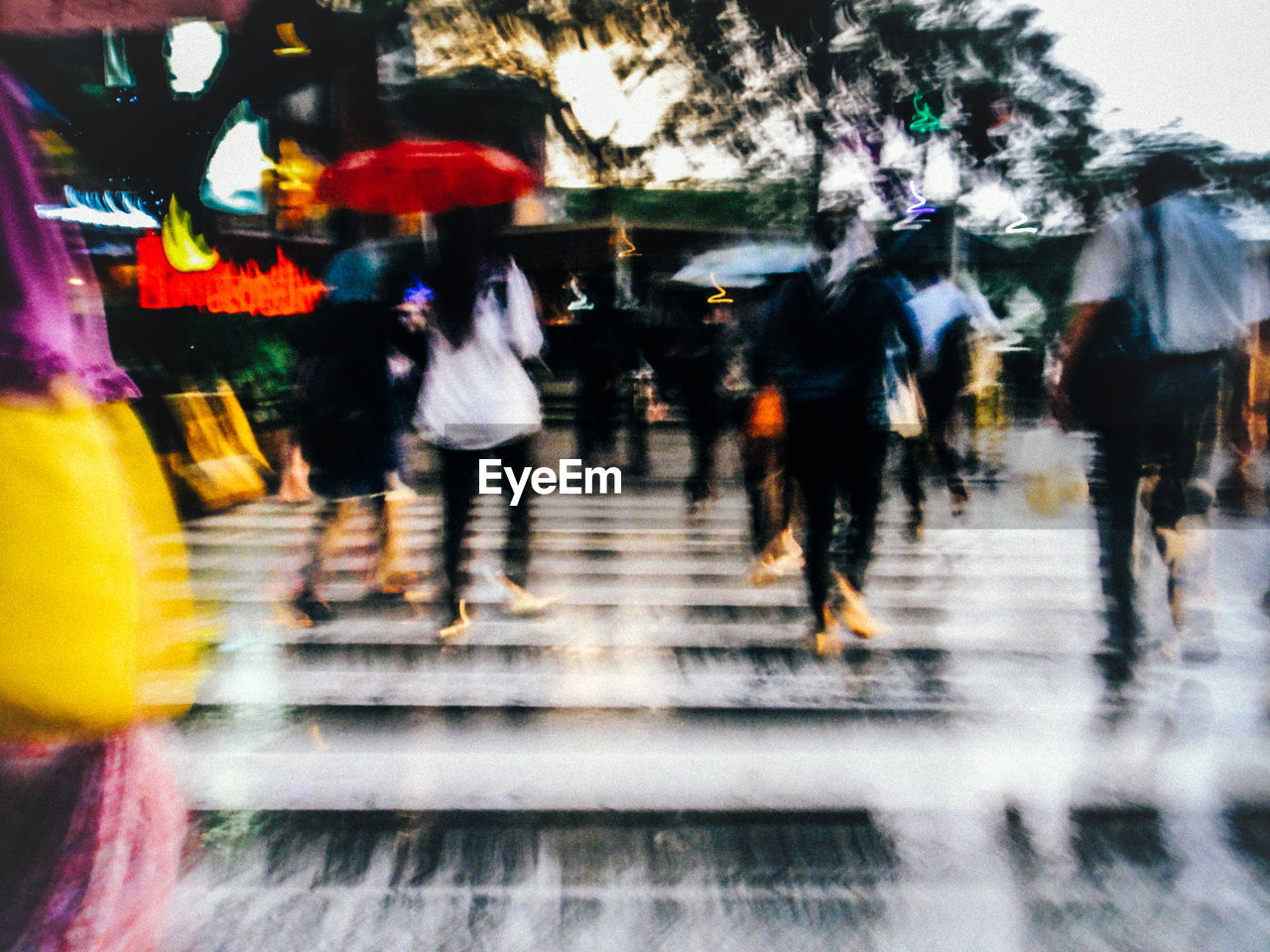 BLURRED MOTION OF PEOPLE WALKING IN THE DARK