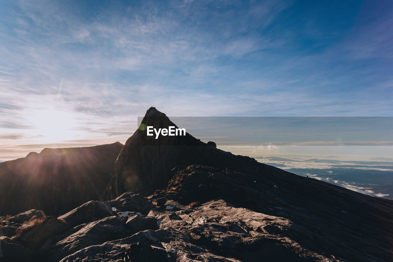 VIEW OF MOUNTAIN RANGE AGAINST CLOUDY SKY