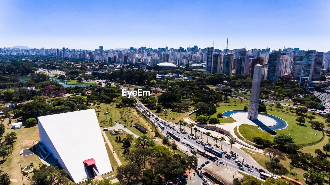 HIGH ANGLE VIEW OF CITYSCAPE AGAINST CLEAR BLUE SKY