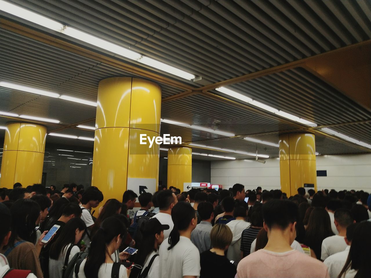 Group of people waiting on railway station platform