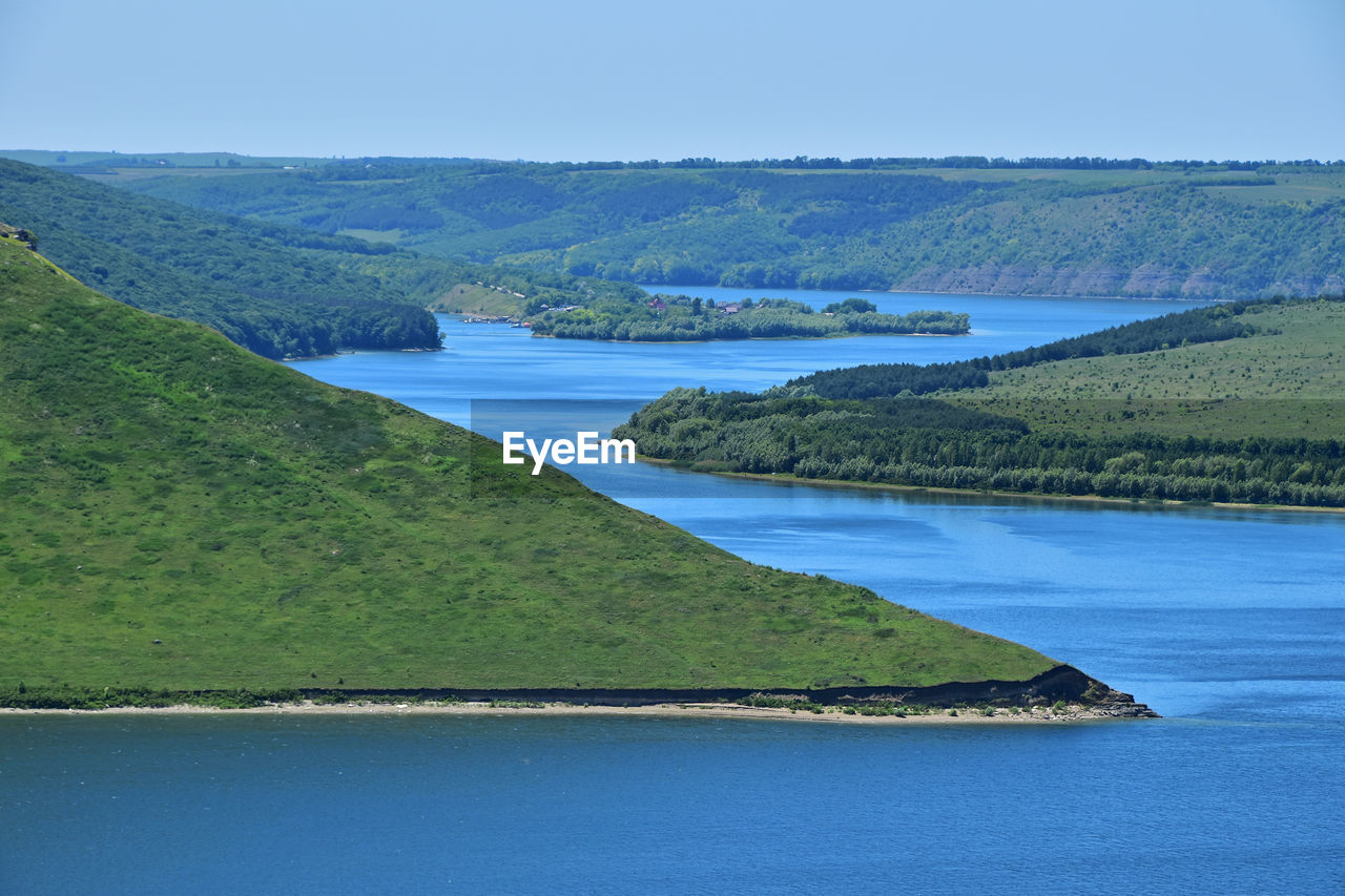 Scenic view of river amidst mountains against sky