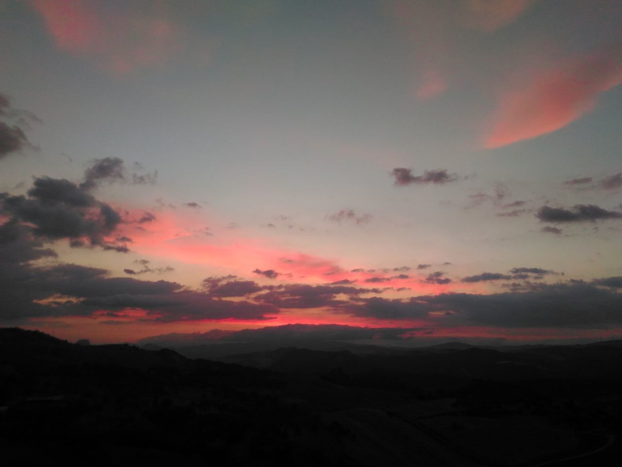 SCENIC VIEW OF MOUNTAINS AT SUNSET