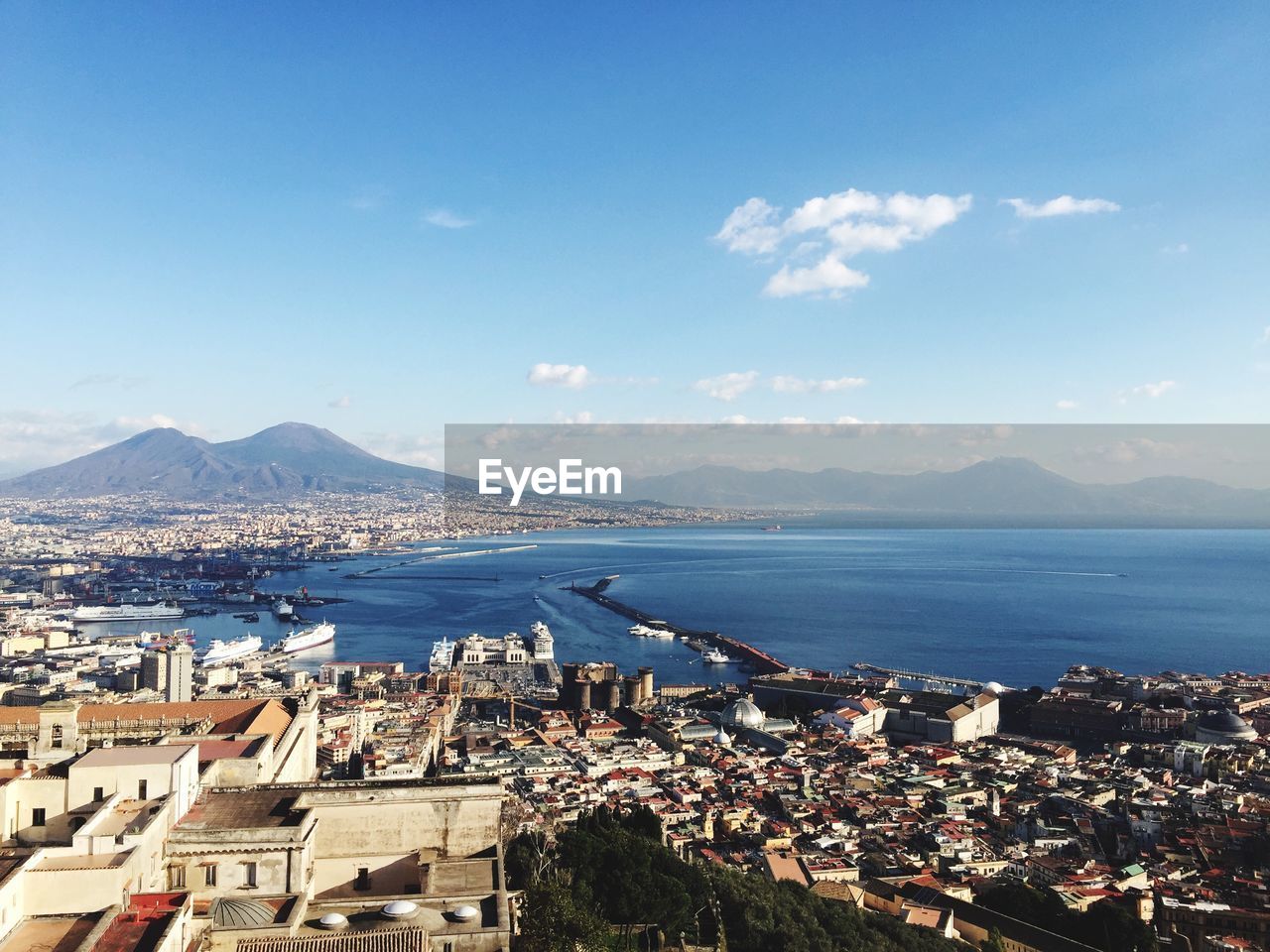 High angle view of townscape by sea against sky