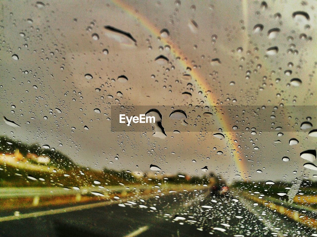 ROAD SEEN THROUGH WET WINDOW