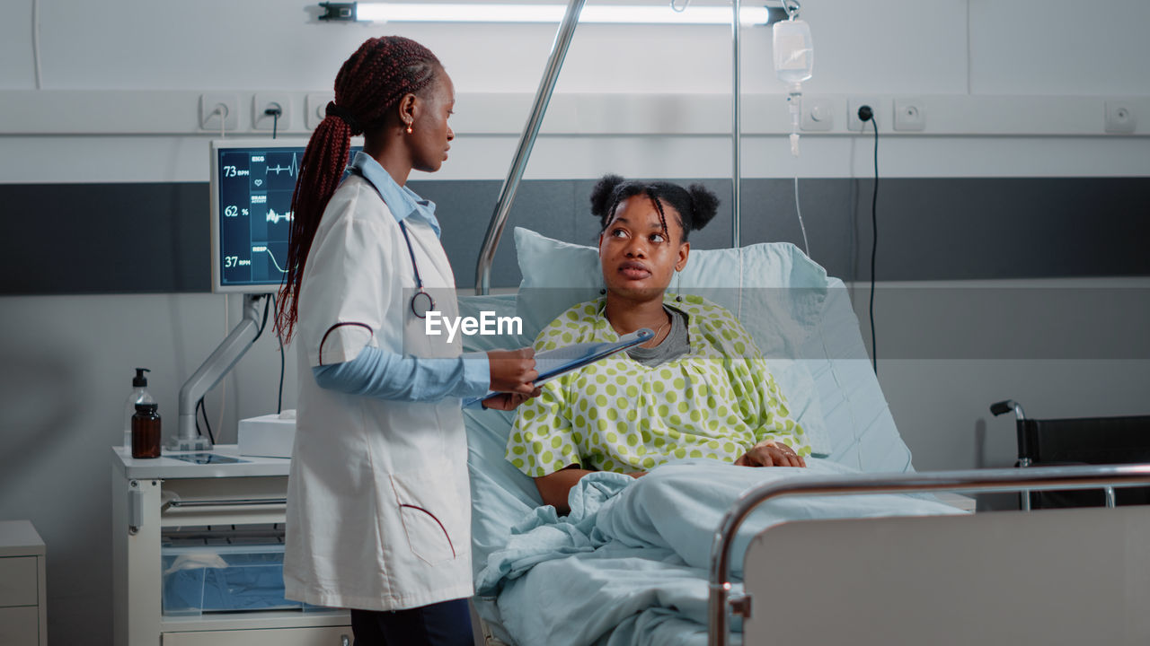 Female doctor examining patient in hospital