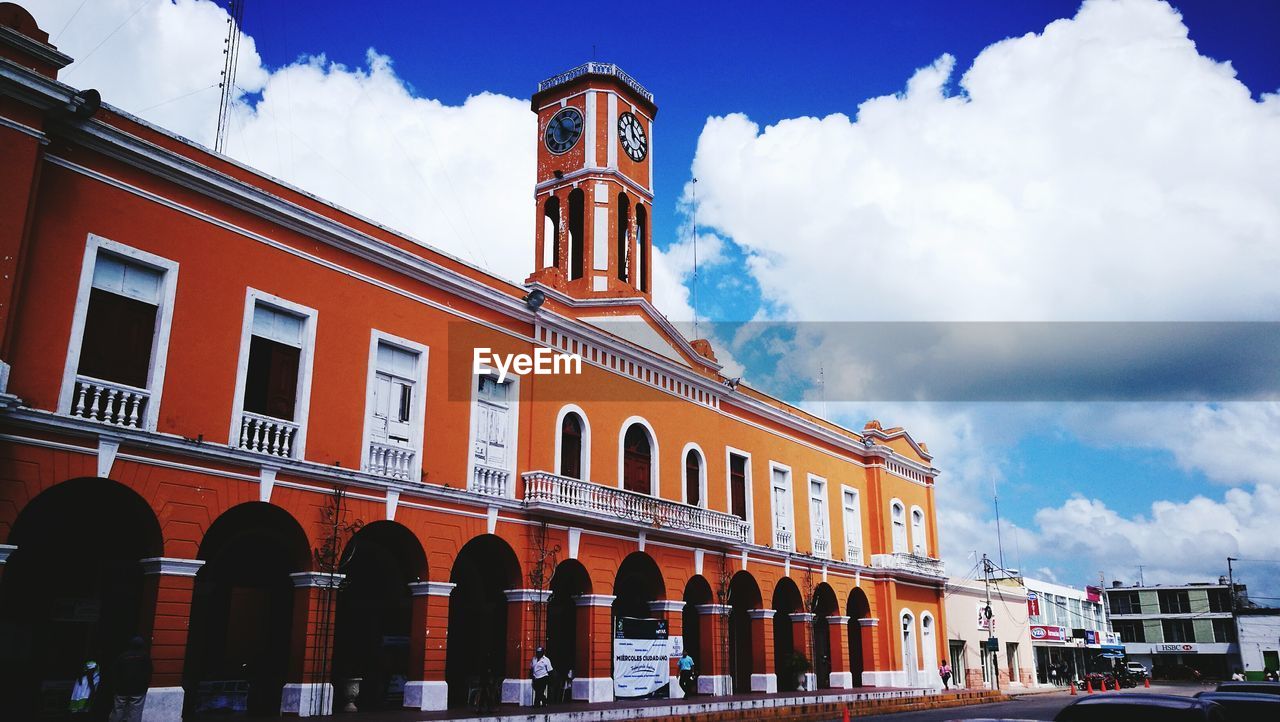 VIEW OF BUILDING AGAINST CLOUDY SKY