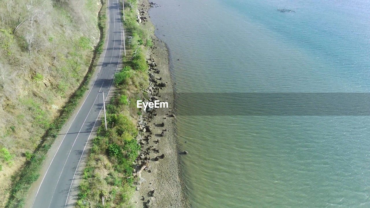 high angle view, water, infrastructure, reservoir, day, transportation, nature, road, beauty in nature, waterway, land, no people, plant, scenics - nature, sea, tranquility, tranquil scene, beach, channel, coast, outdoors, levee, green, non-urban scene, aerial photography, highway, growth