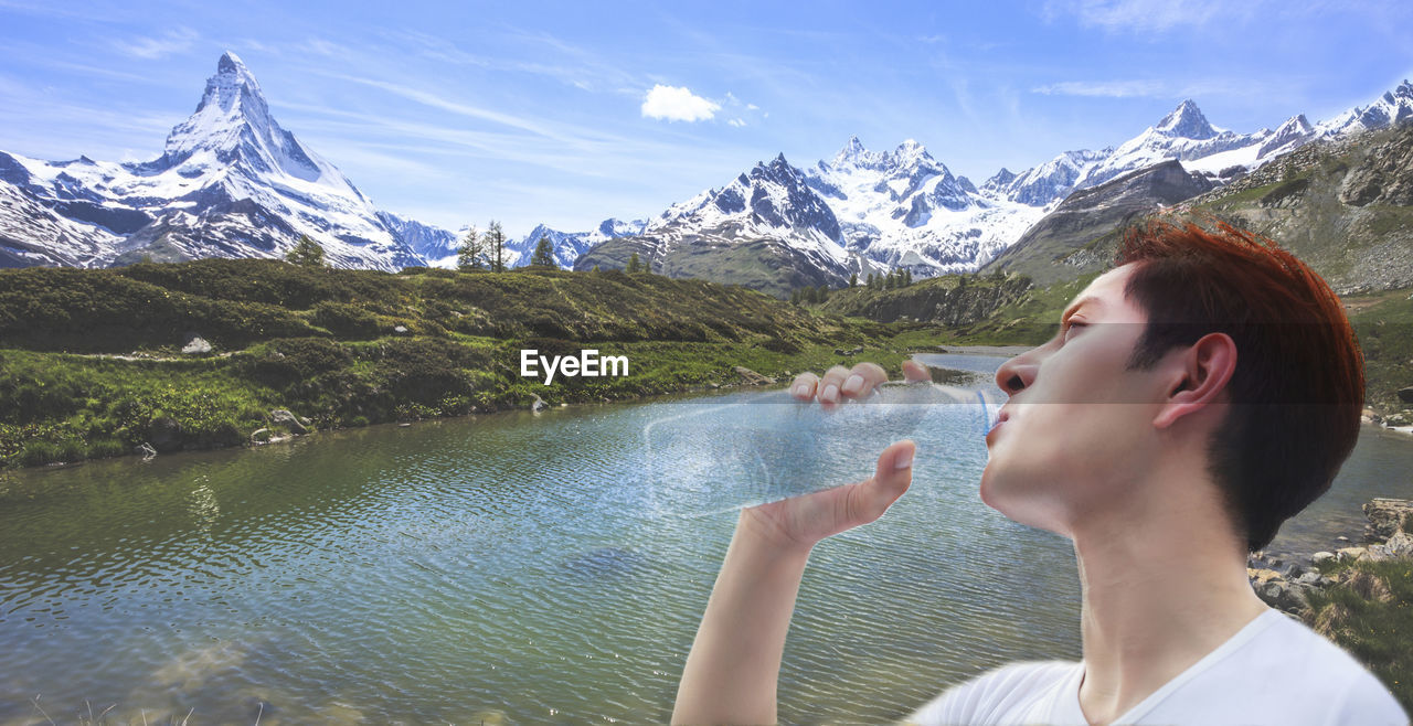 Digital composite image of man drinking water against river 