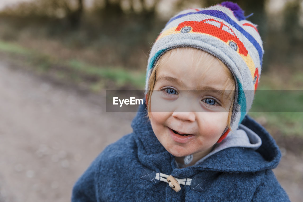 Portrait of cute girl wearing warm clothing outdoors