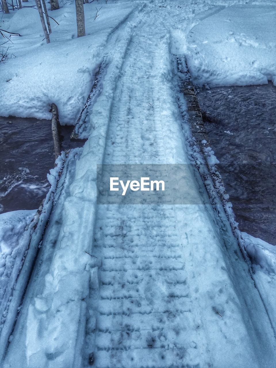 CLOSE-UP OF TIRE TRACKS ON SNOW