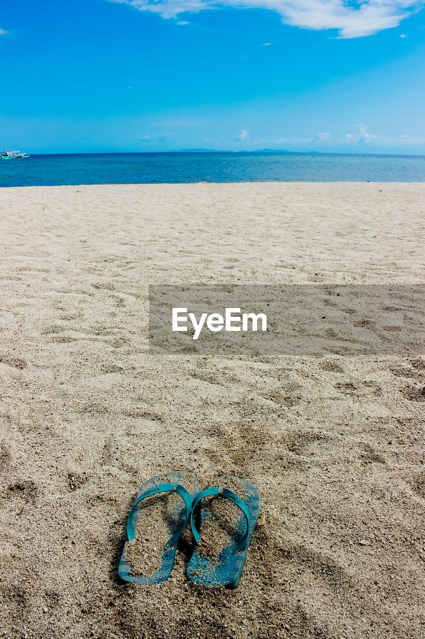 VIEW OF BEACH AGAINST BLUE SKY