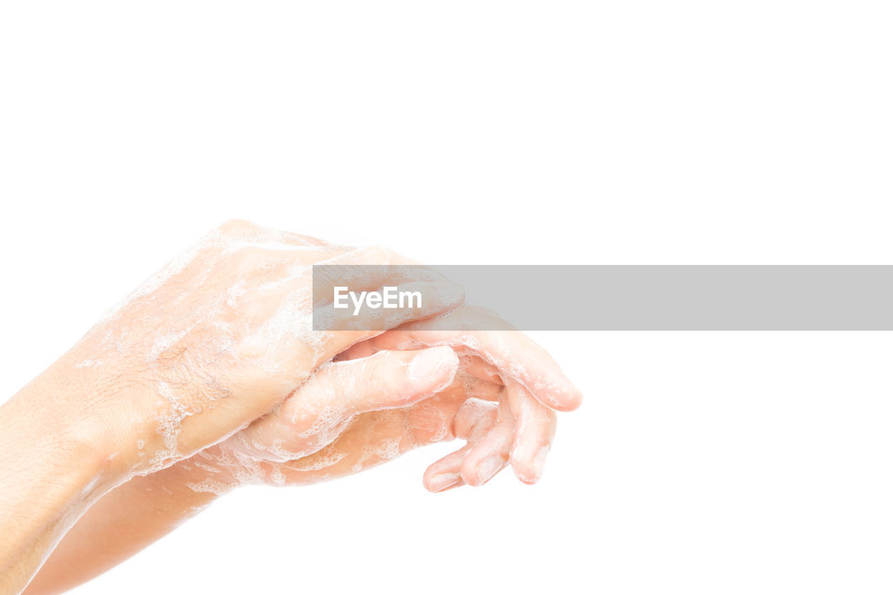 Cropped image of women cleaning hands against white background