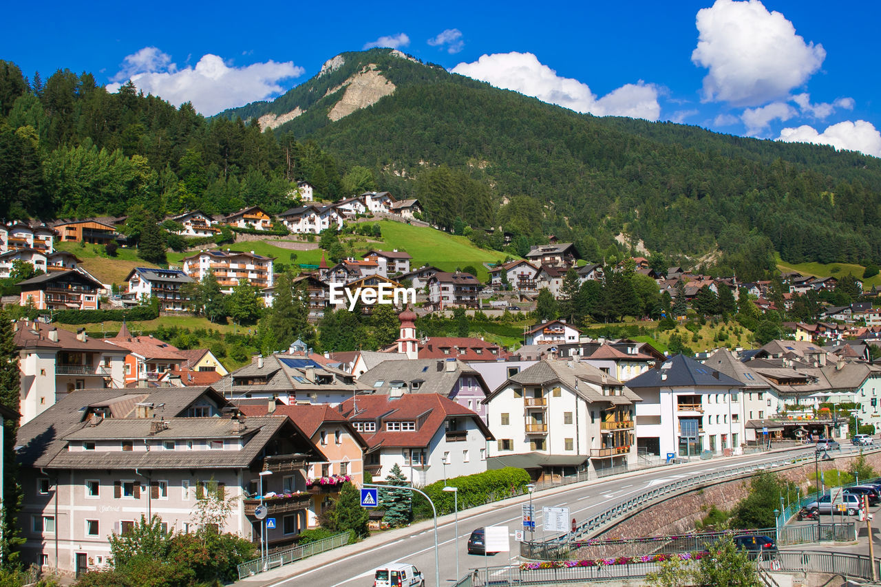 High angle view of townscape by mountain against sky