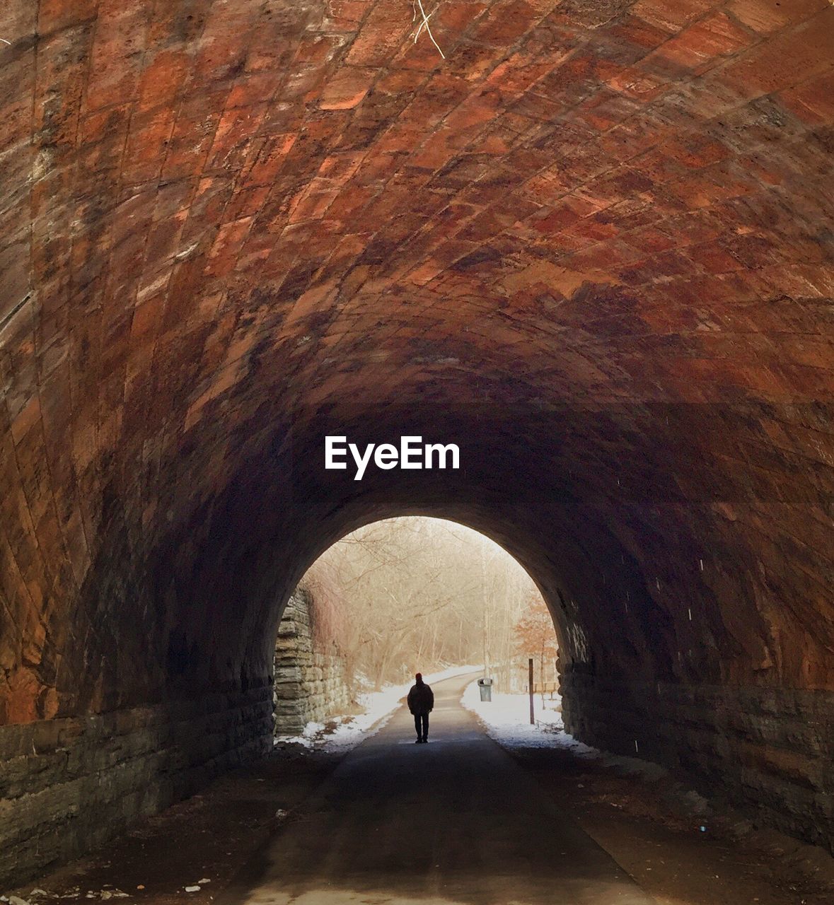 Person standing in tunnel