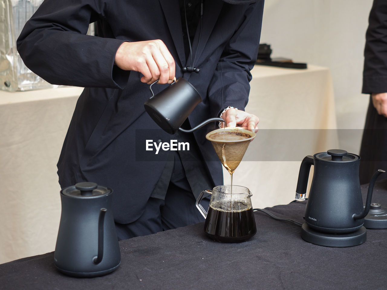 MIDSECTION OF MAN WORKING WITH COFFEE CUP AND WINE