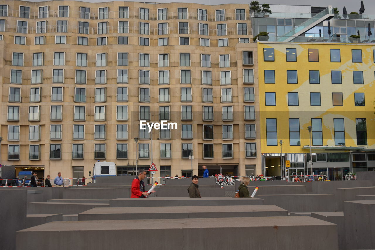 GROUP OF PEOPLE IN FRONT OF BUILDING