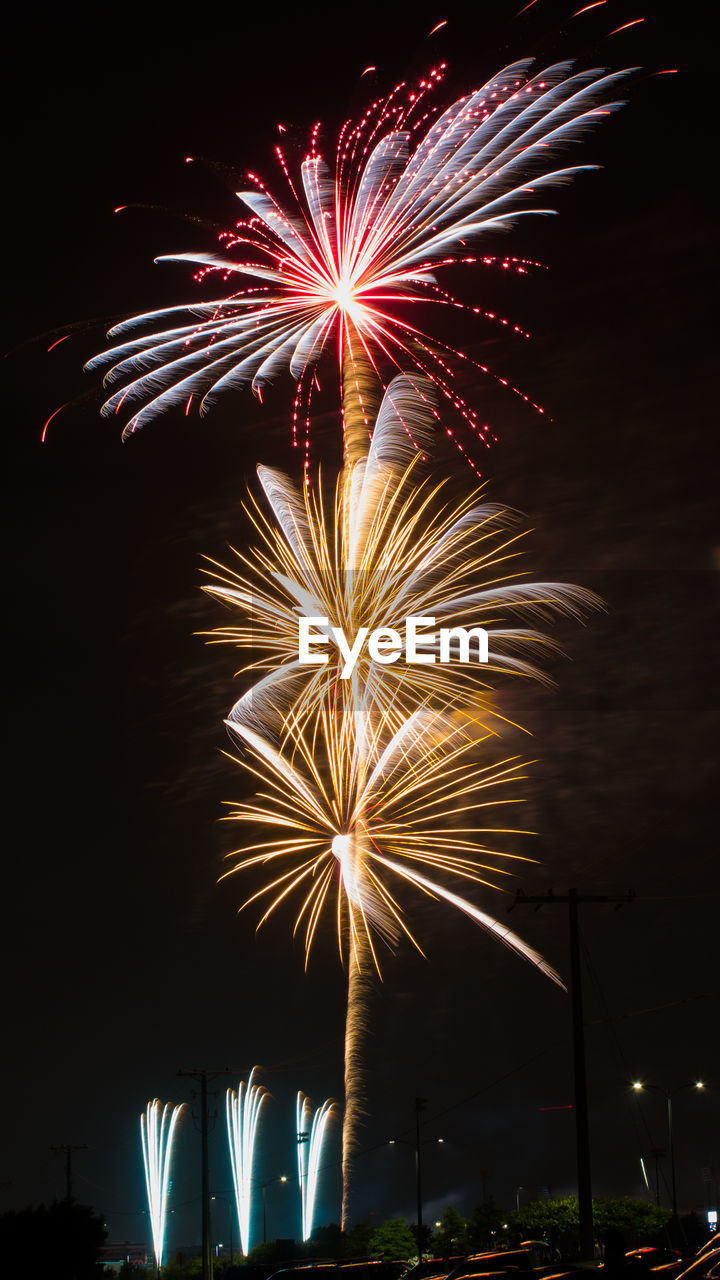 LOW ANGLE VIEW OF FIREWORK DISPLAY IN SKY