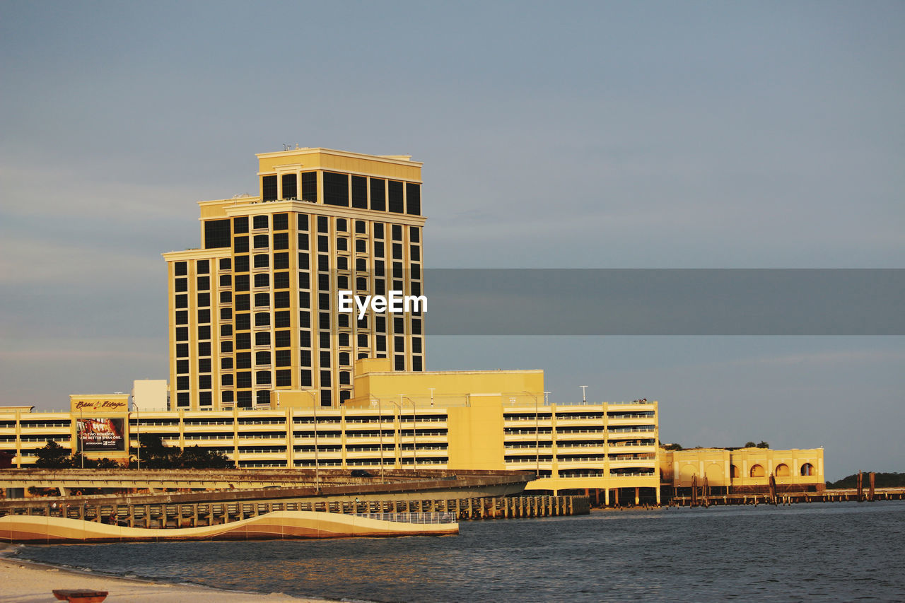 Buildings in city against sky during sunset