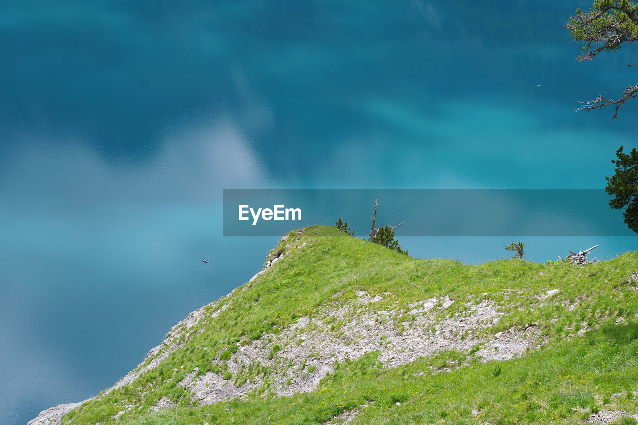 View of lizard on rock against sky