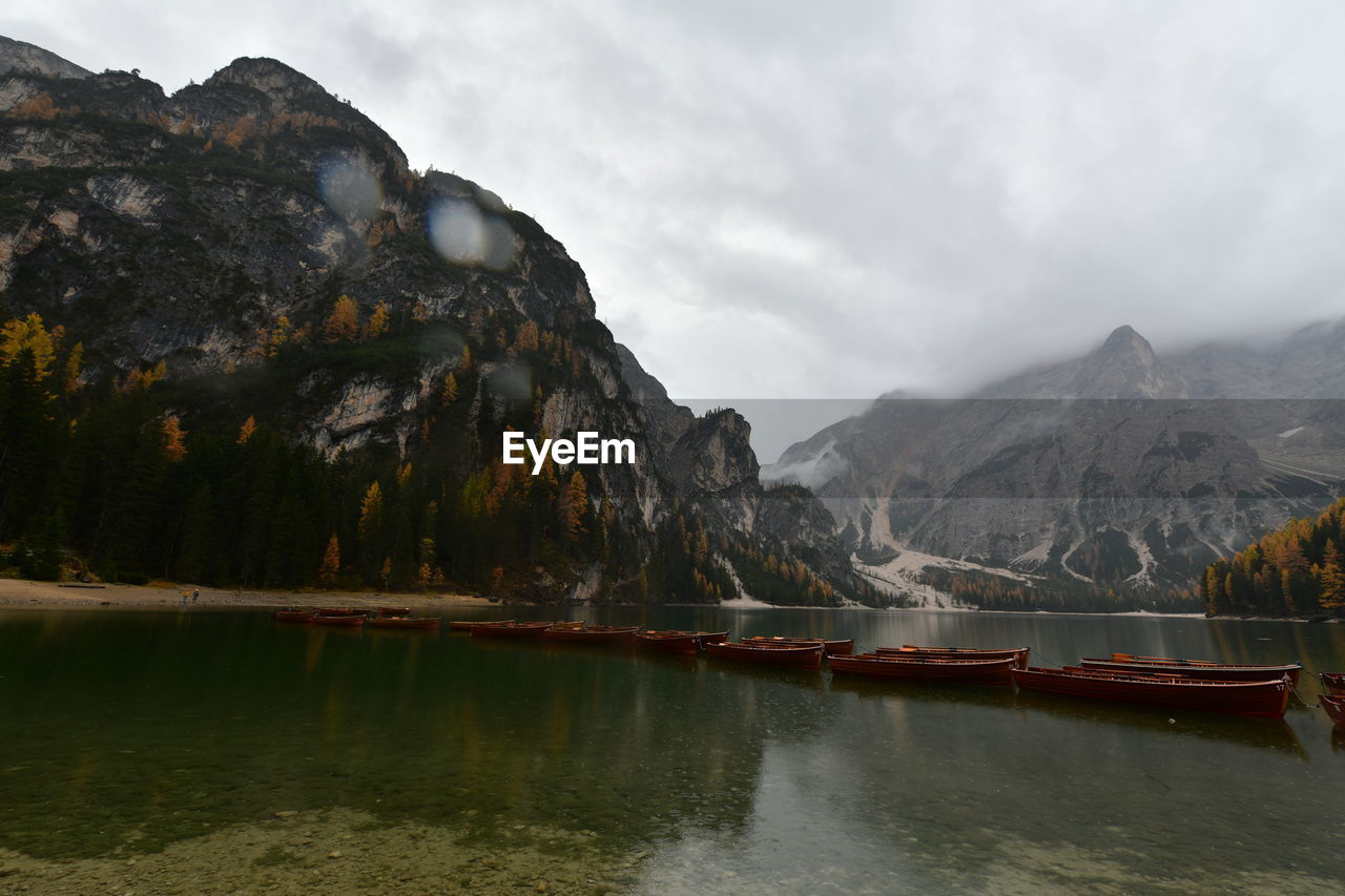 Scenic view of lake by mountains against sky