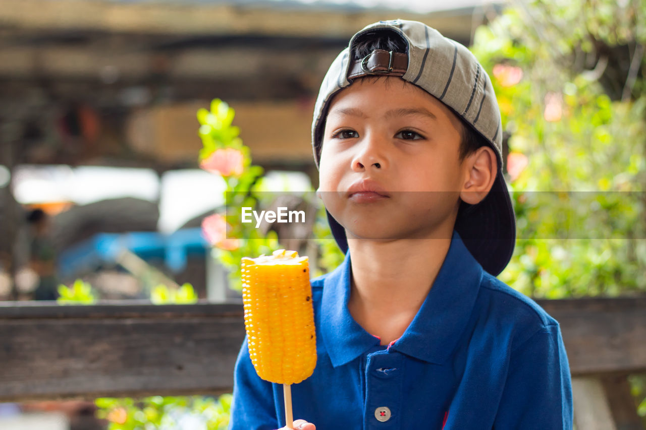 Close-up of boy eating corn