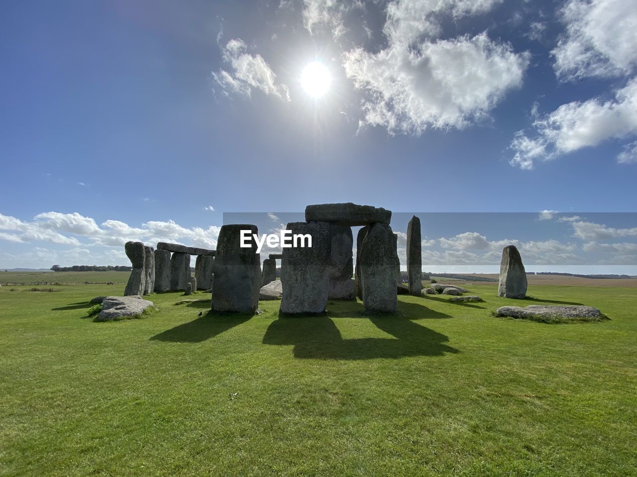 Stone circle on field against sky