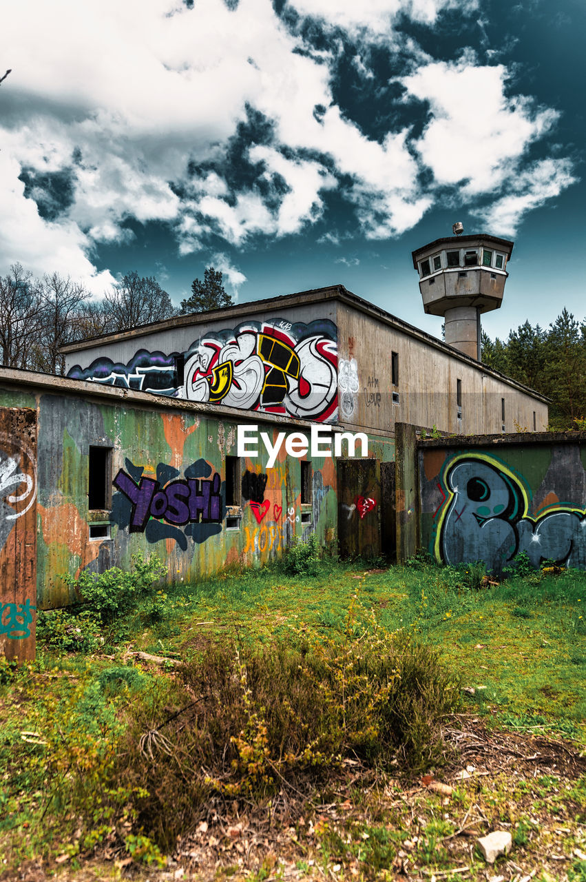 GRAFFITI ON HOUSE AGAINST SKY