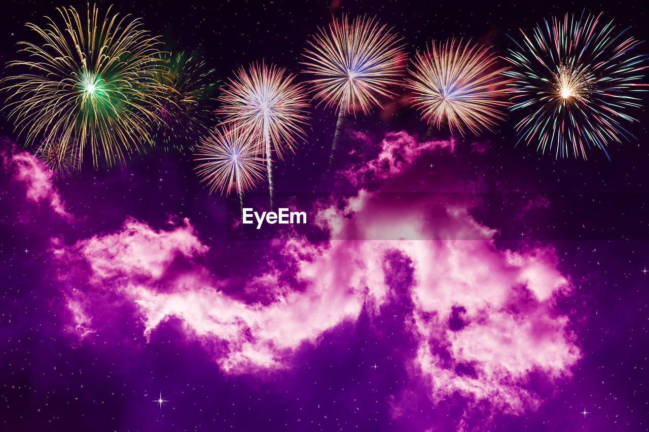 LOW ANGLE VIEW OF FIREWORK DISPLAY AT NIGHT
