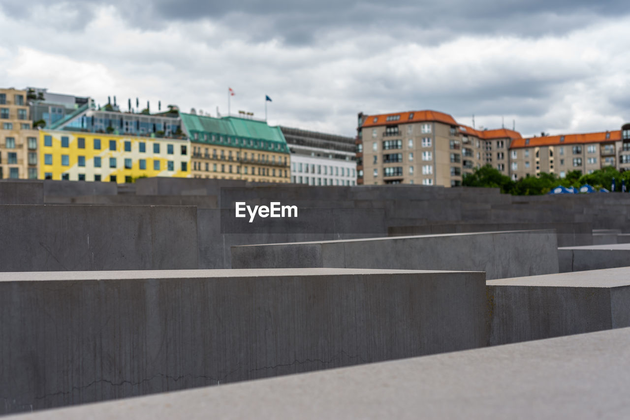 BUILDINGS AGAINST CLOUDY SKY