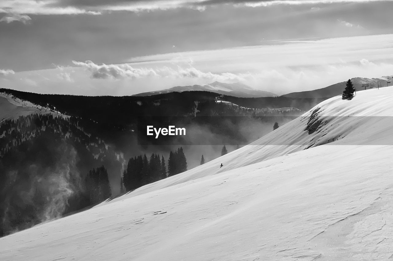 mountain, snow, environment, cold temperature, landscape, scenics - nature, winter, beauty in nature, mountain range, black and white, sky, cloud, nature, land, winter sports, monochrome photography, white, sports, travel, travel destinations, monochrome, snowcapped mountain, skiing, adventure, non-urban scene, leisure activity, vacation, holiday, trip, tourism, day, outdoors, tranquil scene, tranquility, activity, extreme sports, motion, fog, mountain peak, ski