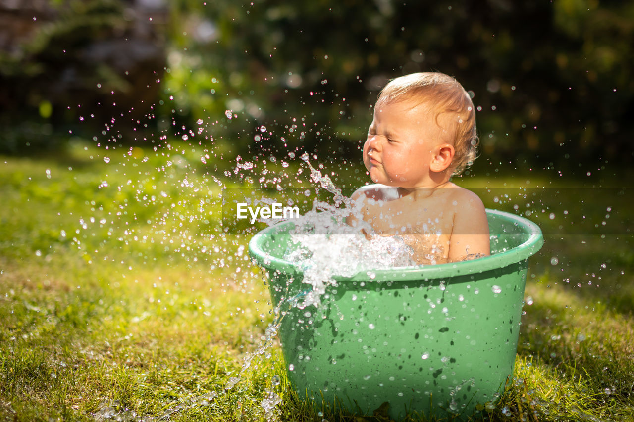 Boy looking away in water