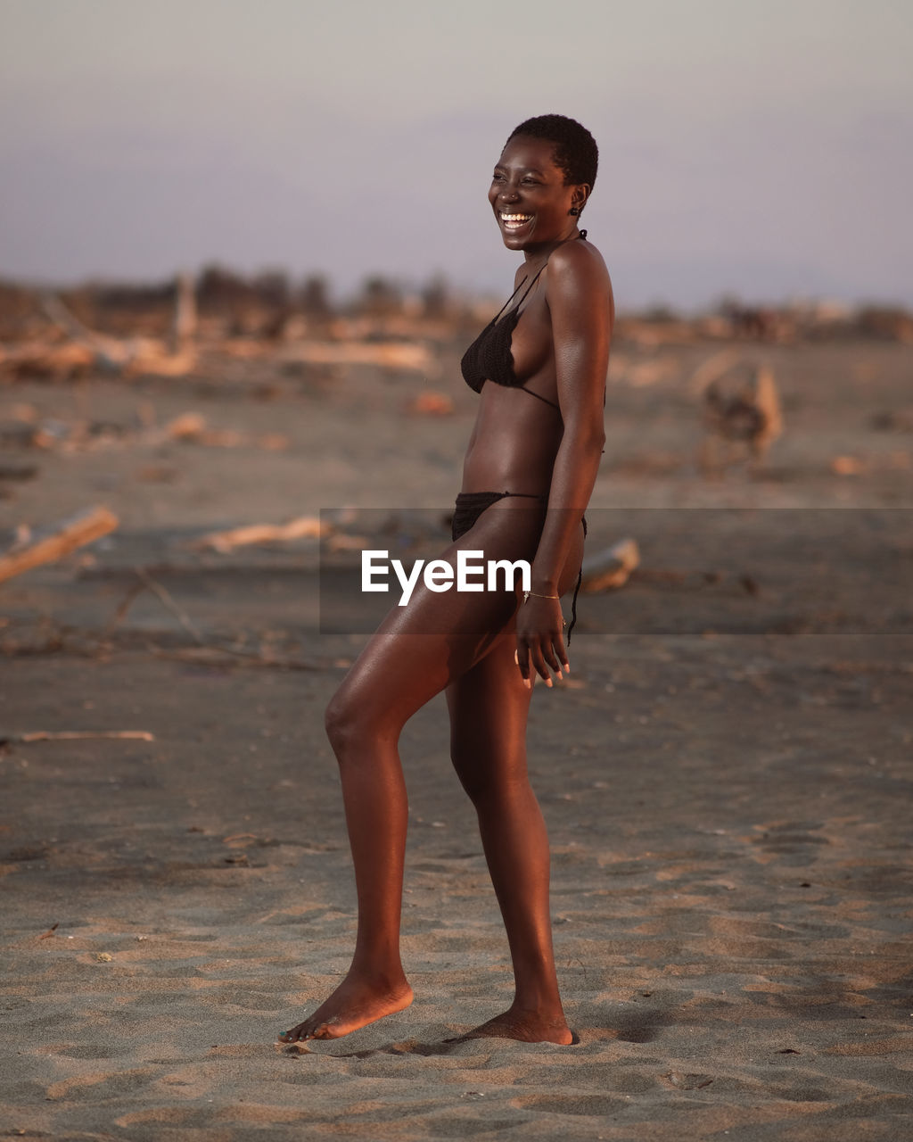 Full length portrait of woman standing on beach