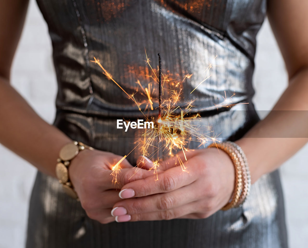 Midsection of woman holding sparkler