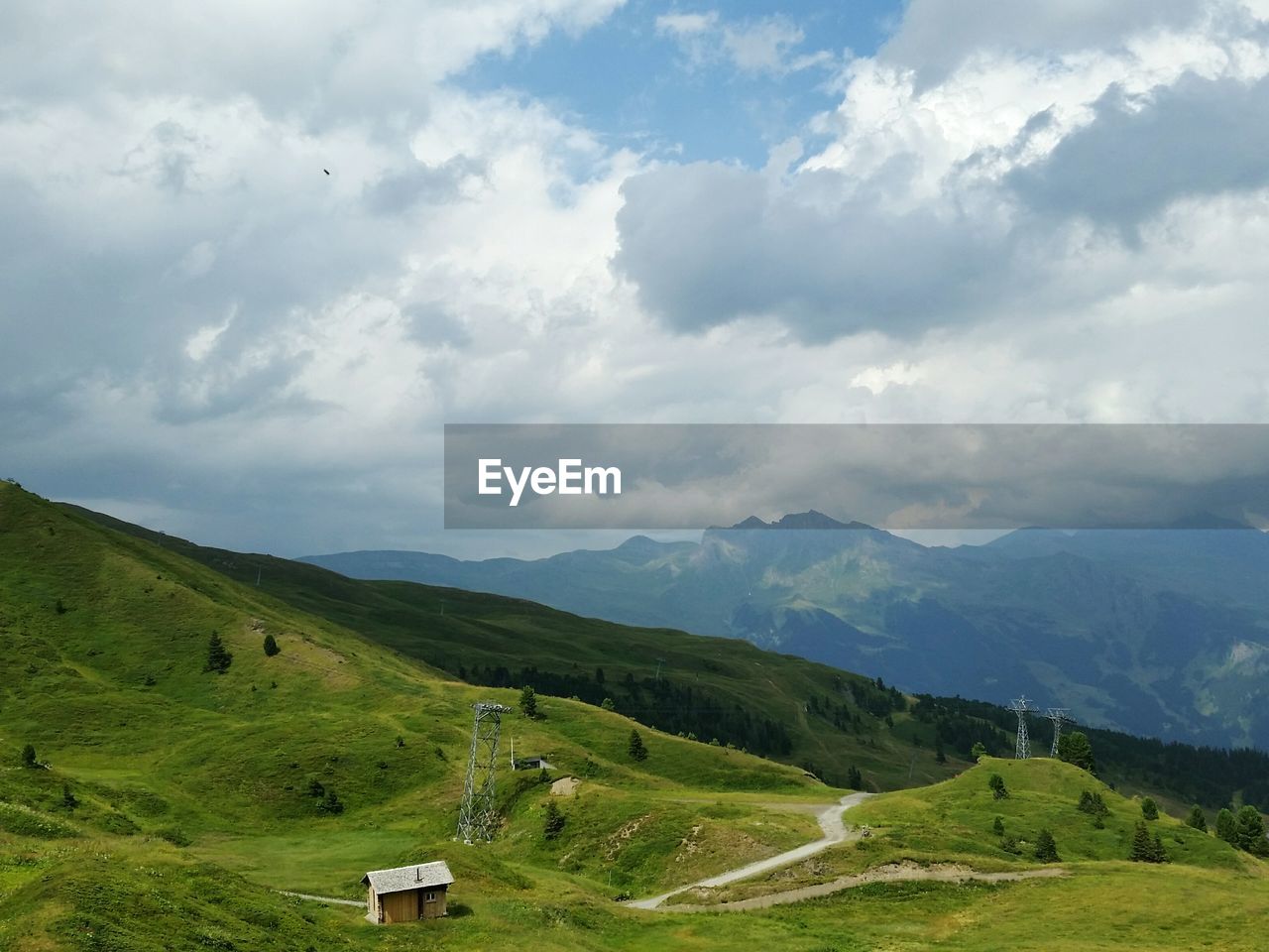 Scenic view of mountains against cloudy sky