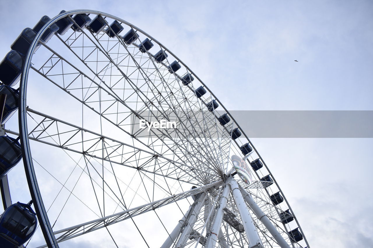 LOW ANGLE VIEW OF WHEEL AGAINST SKY