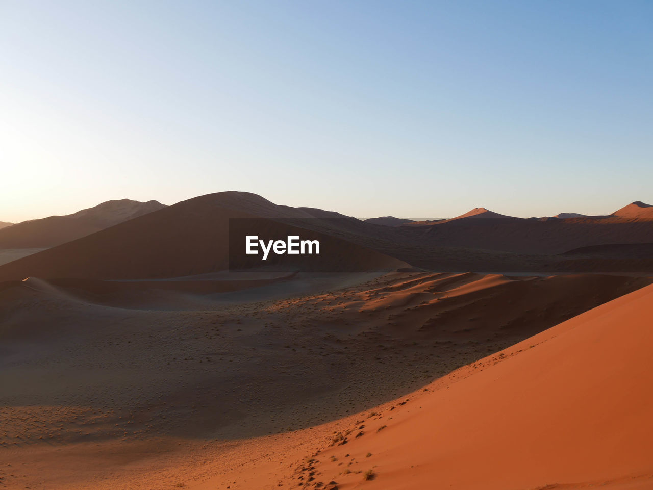 scenic view of desert against clear blue sky