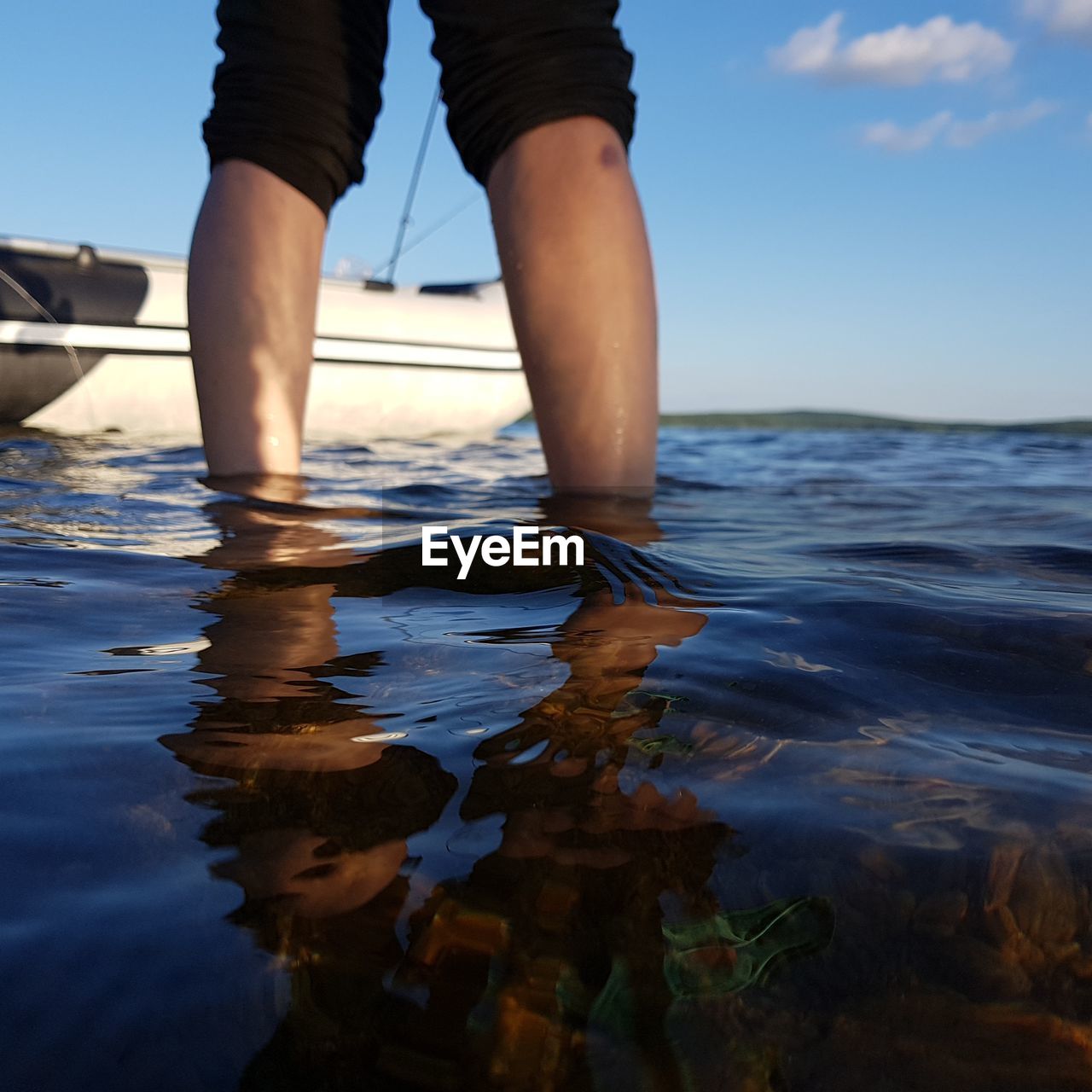 LOW SECTION OF WOMAN IN SEA