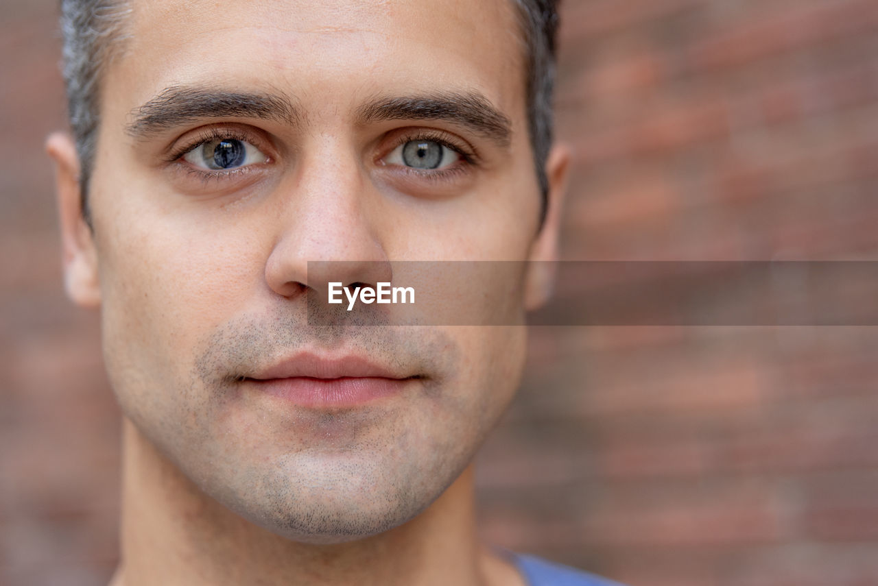 Close up portrait of latin man with heterochromia