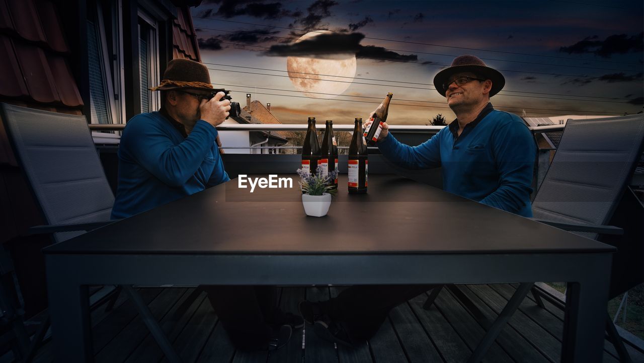 PEOPLE SITTING ON TABLE AT CAFE