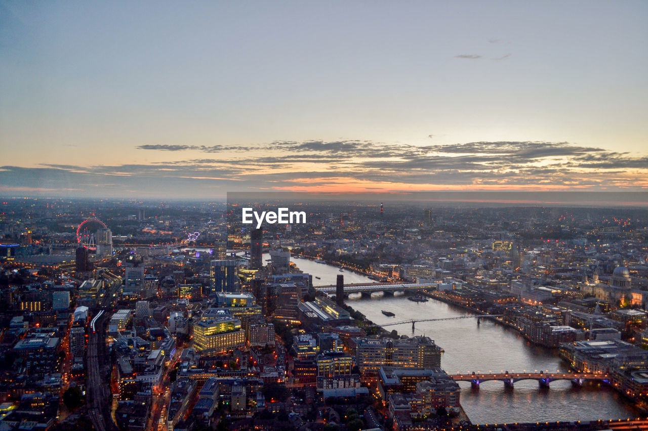 Aerial view of river and city during sunset