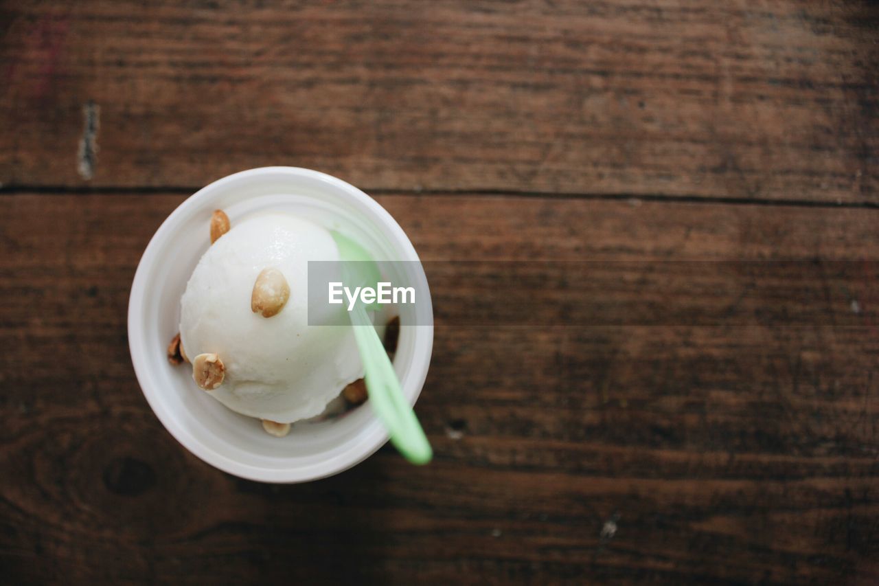 Ice cream served in cup on table