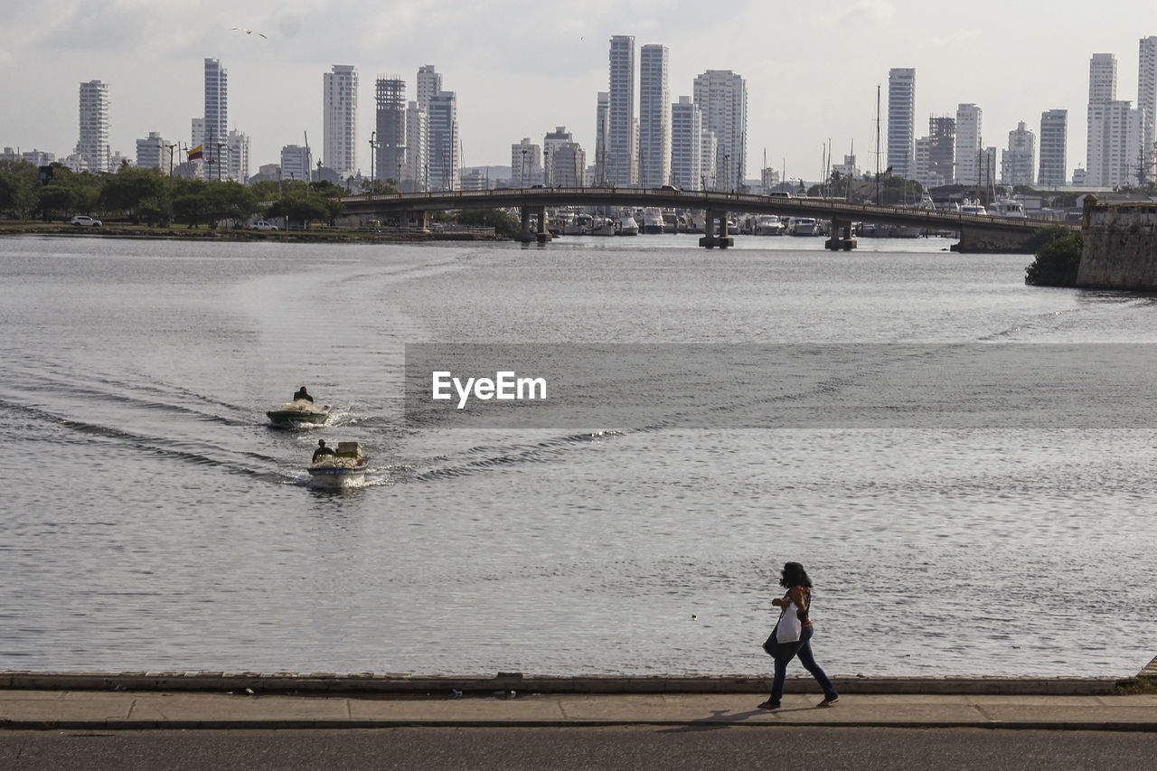 PEOPLE ON BRIDGE IN CITY