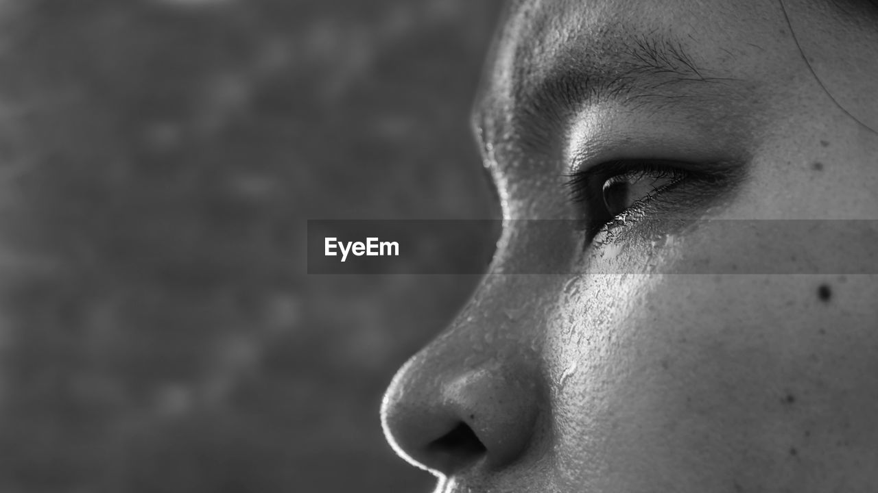 Close-up of sweaty woman looking away