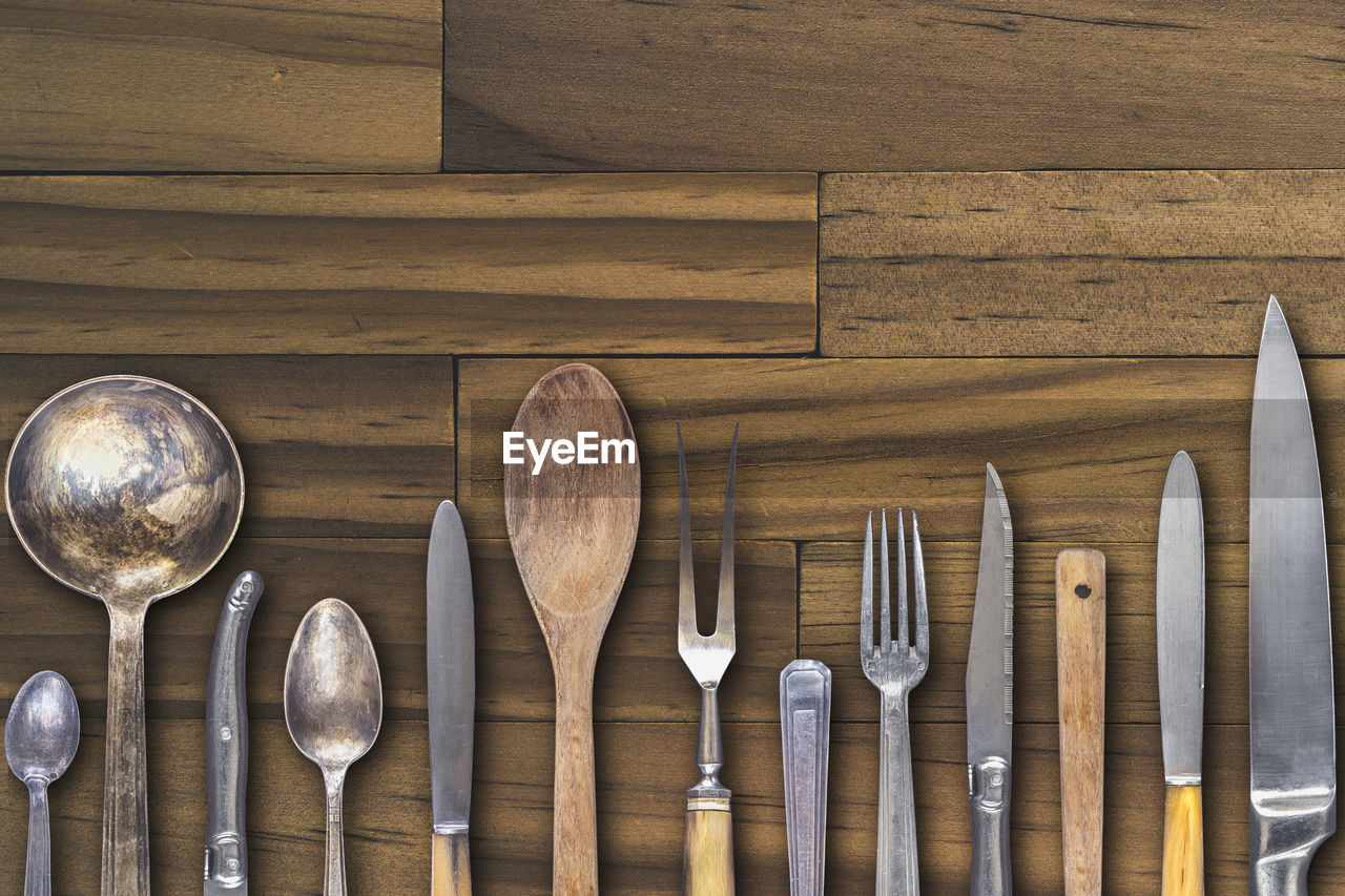 Close-up of kitchen utensils on wooden table