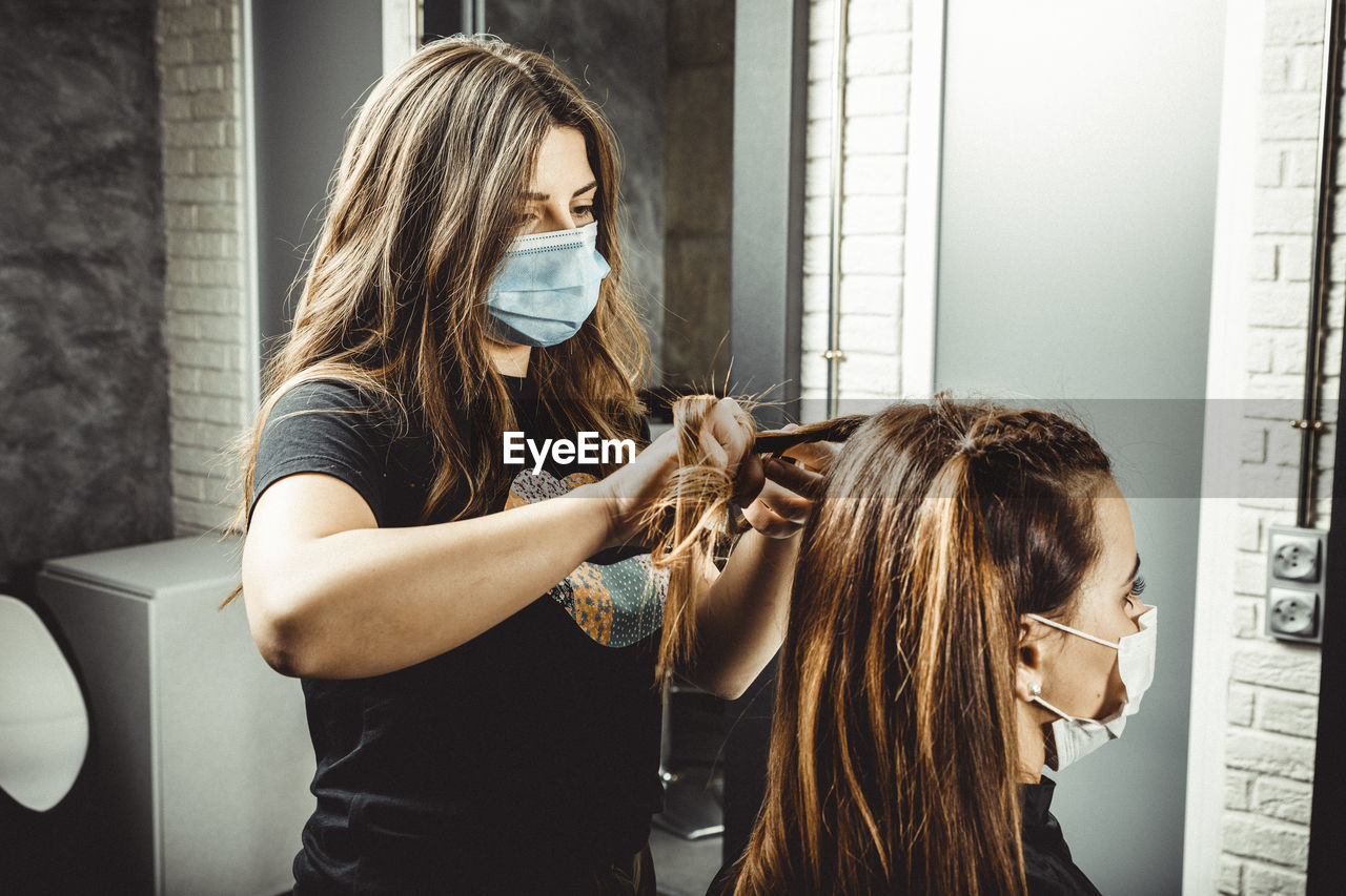 Beautician and hairdresser working with mask for the covid19 virus