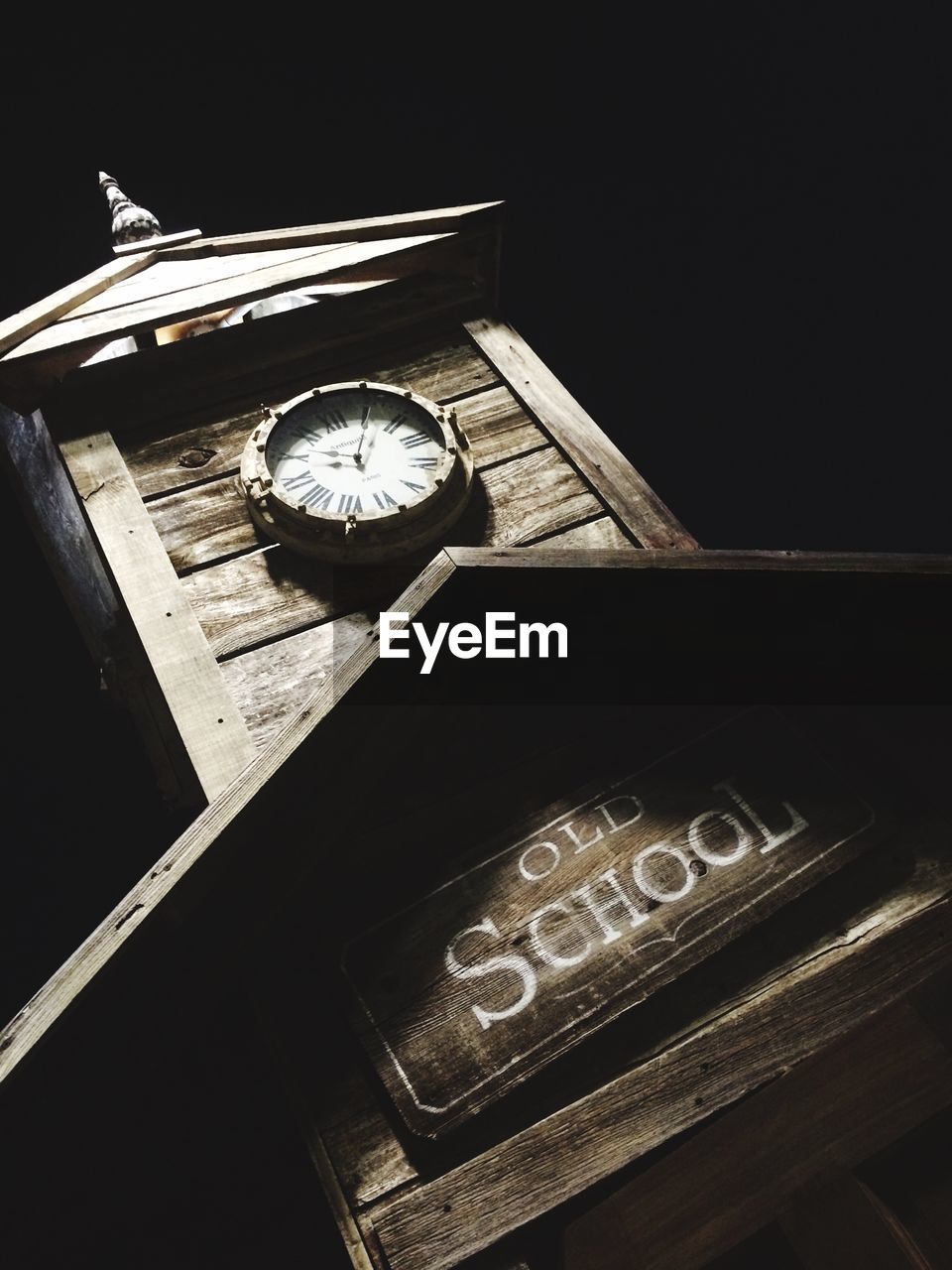 Tilt image of school clock tower at night