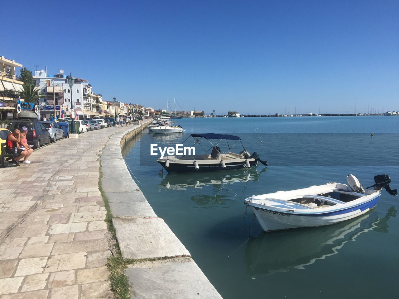 BOATS MOORED AT HARBOR AGAINST CLEAR SKY