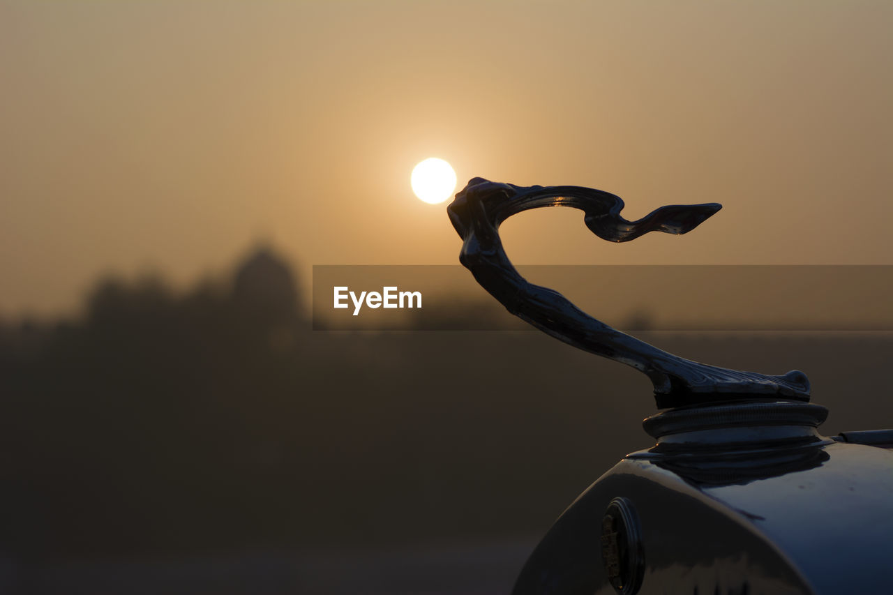 CLOSE-UP OF SILHOUETTE SUN DURING SUNSET