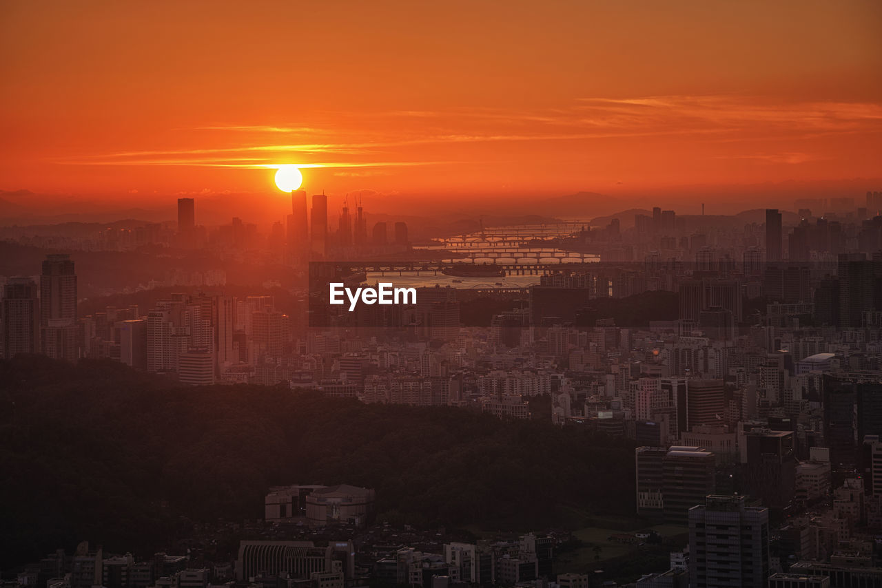 High angle view of buildings against sky during sunset